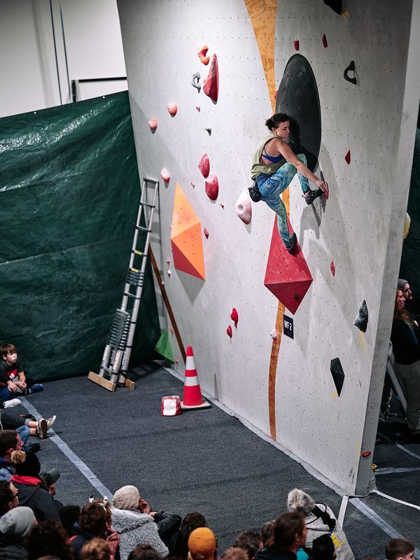 Female competitor on competition boulder problem