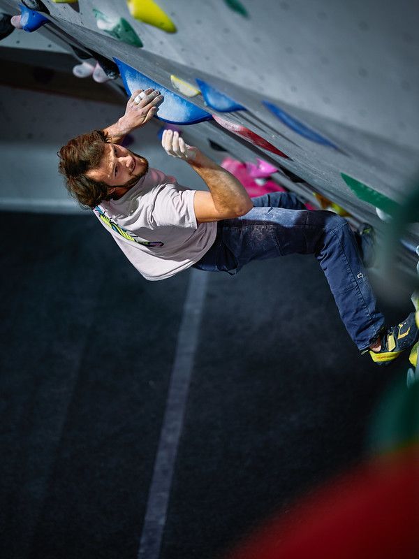 Male competitor on competition boulder problem