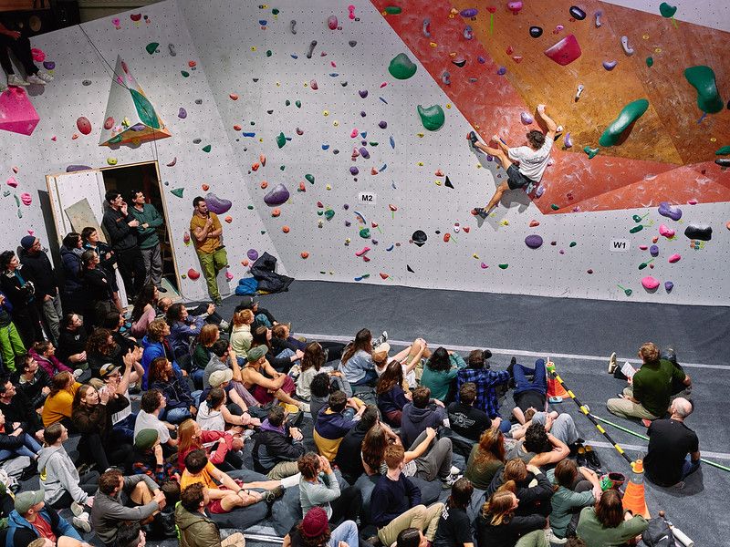 Male competitor on competition boulder problem