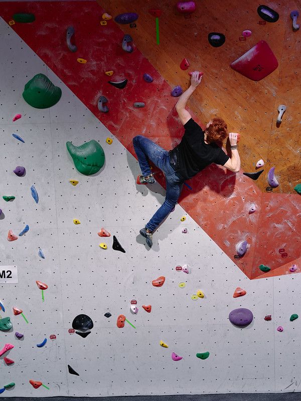 Male competitor on competition boulder problem