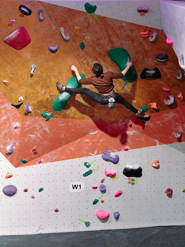 Female competitor on competition boulder problem