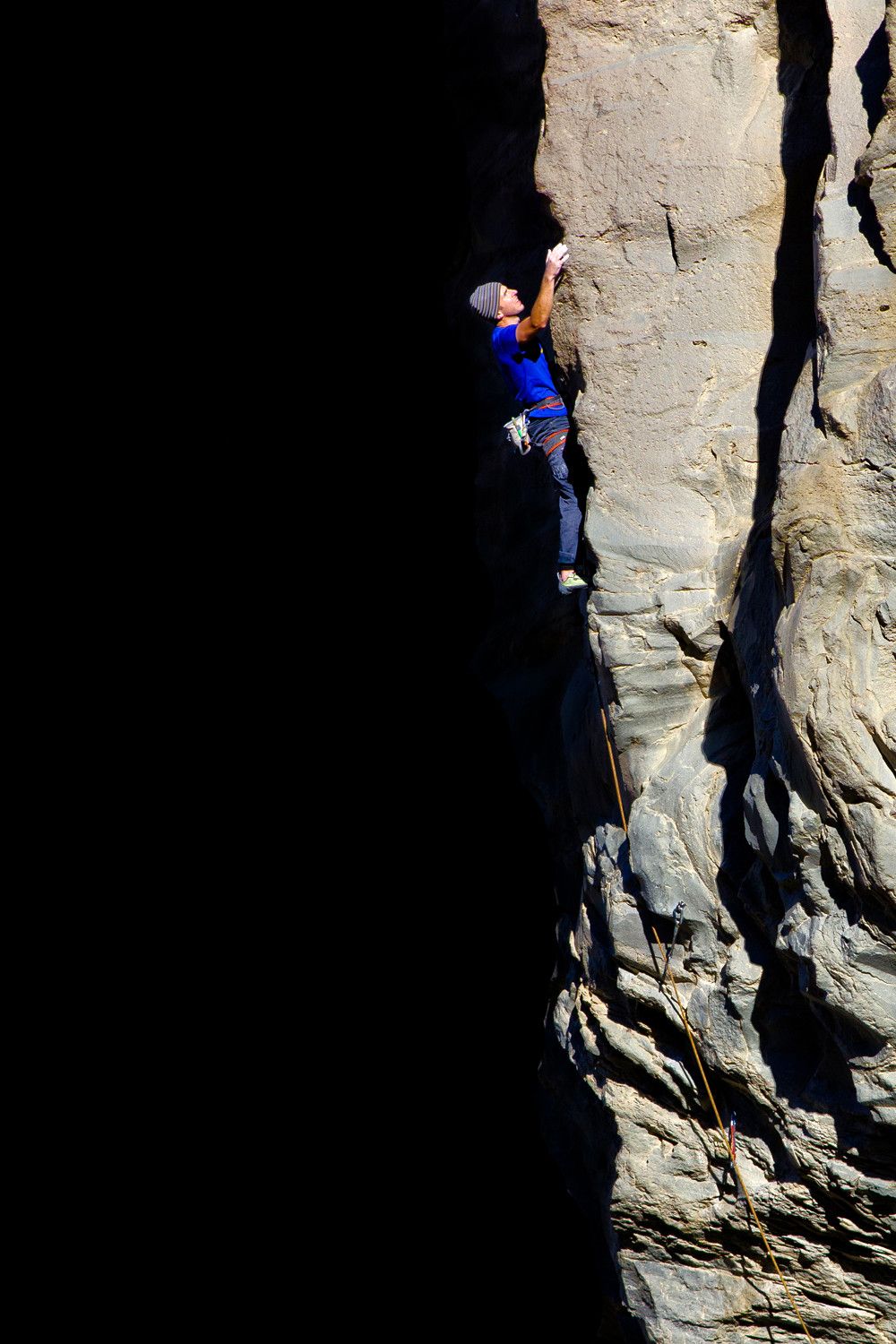 Climber on arête in the line of sun and shade