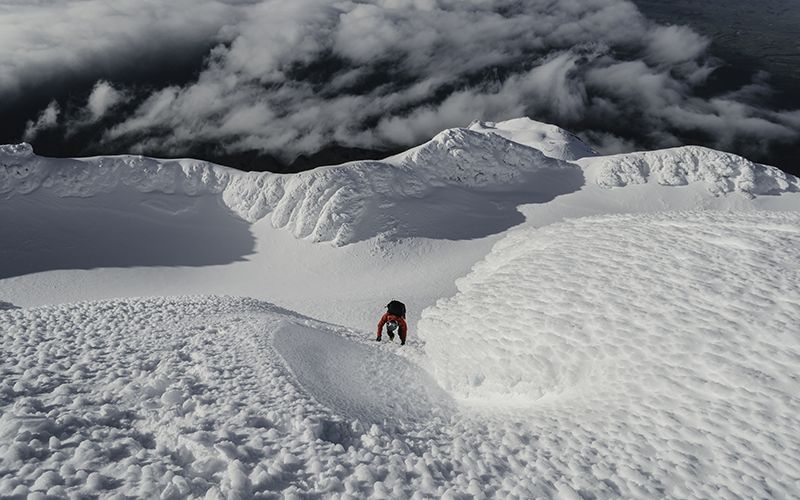 Climber on rimed snow slope