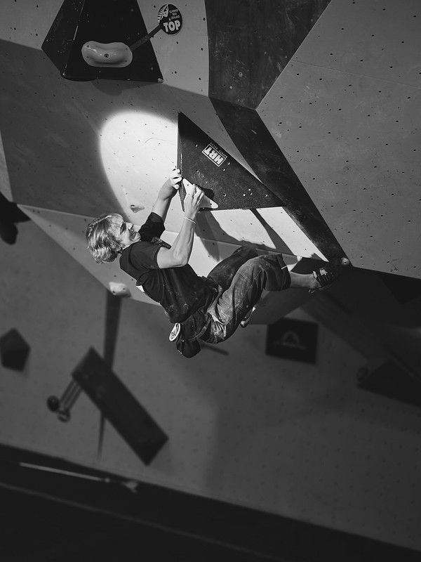 Male competitor on competition boulder problem