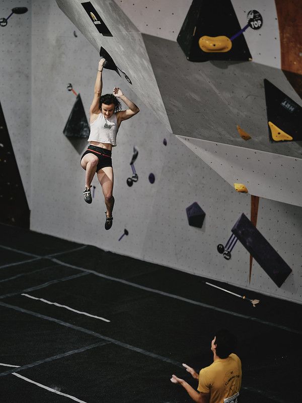 Female competitor on competition boulder problem