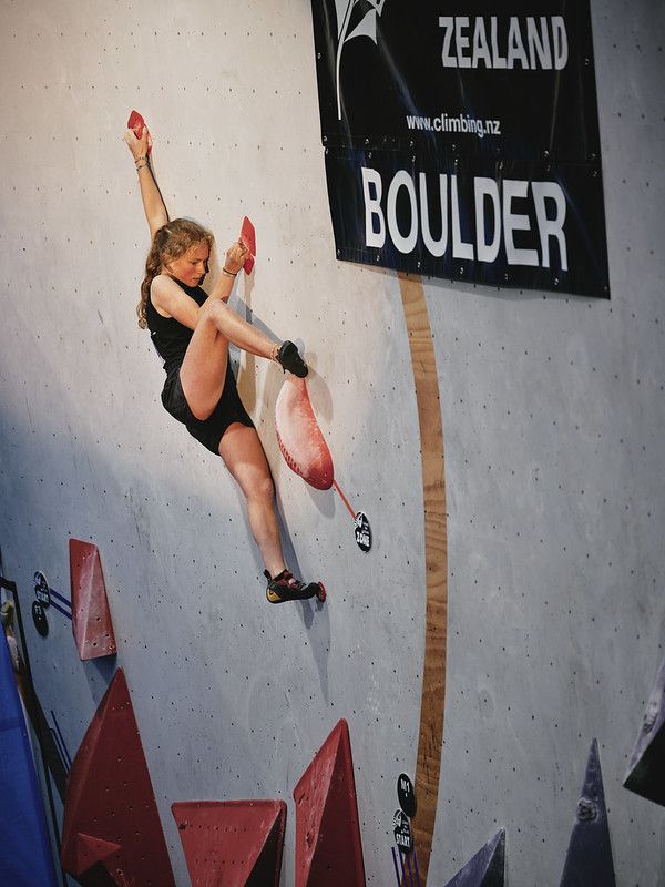 Female competitor on competition boulder problem