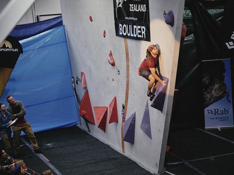 Male competitor on competition boulder problem