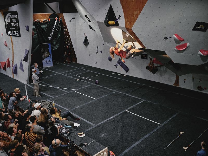 Male competitor on competition boulder problem