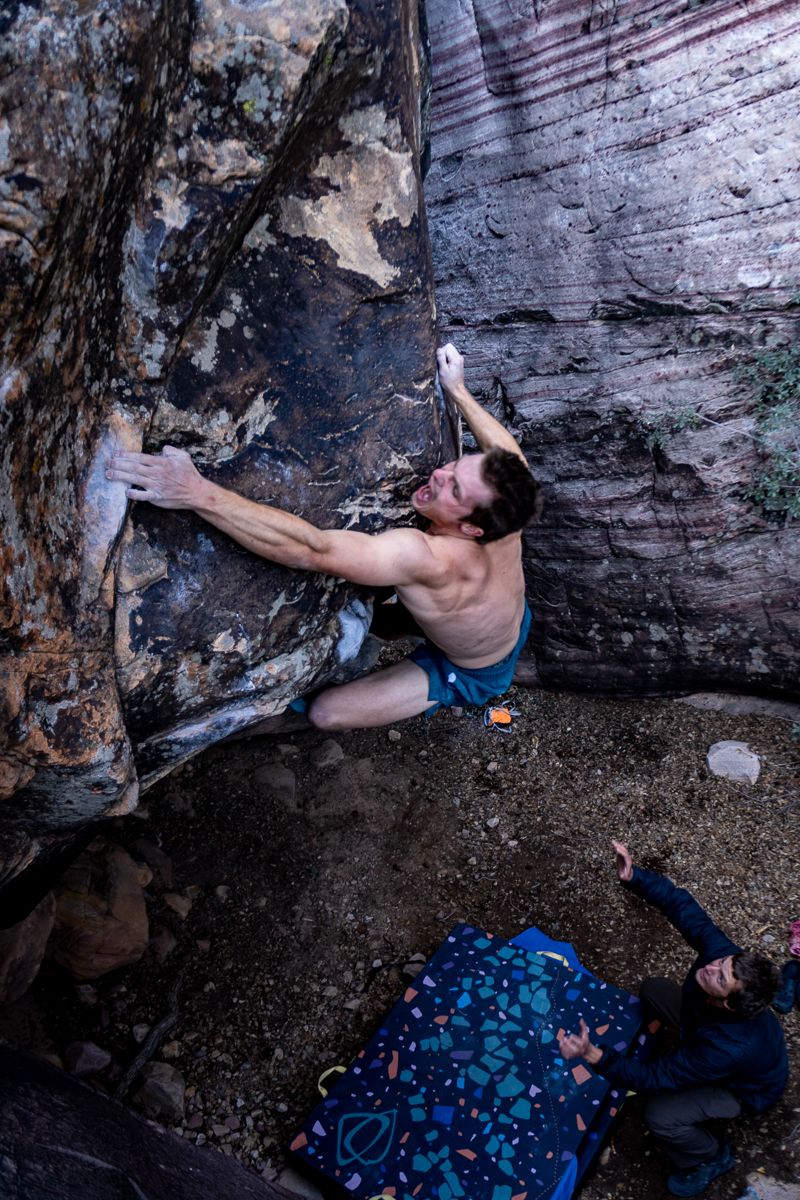 Boulderer with try-hard face