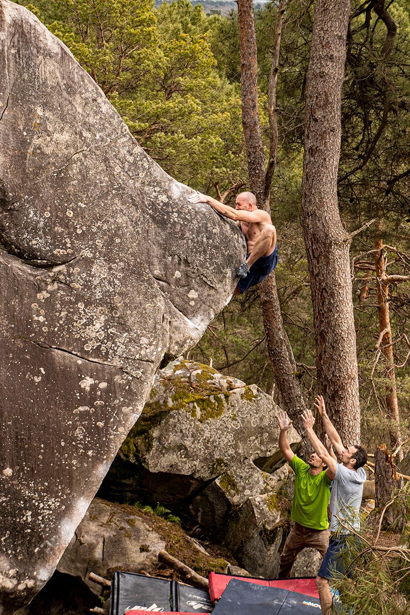 Climber mantles boulder