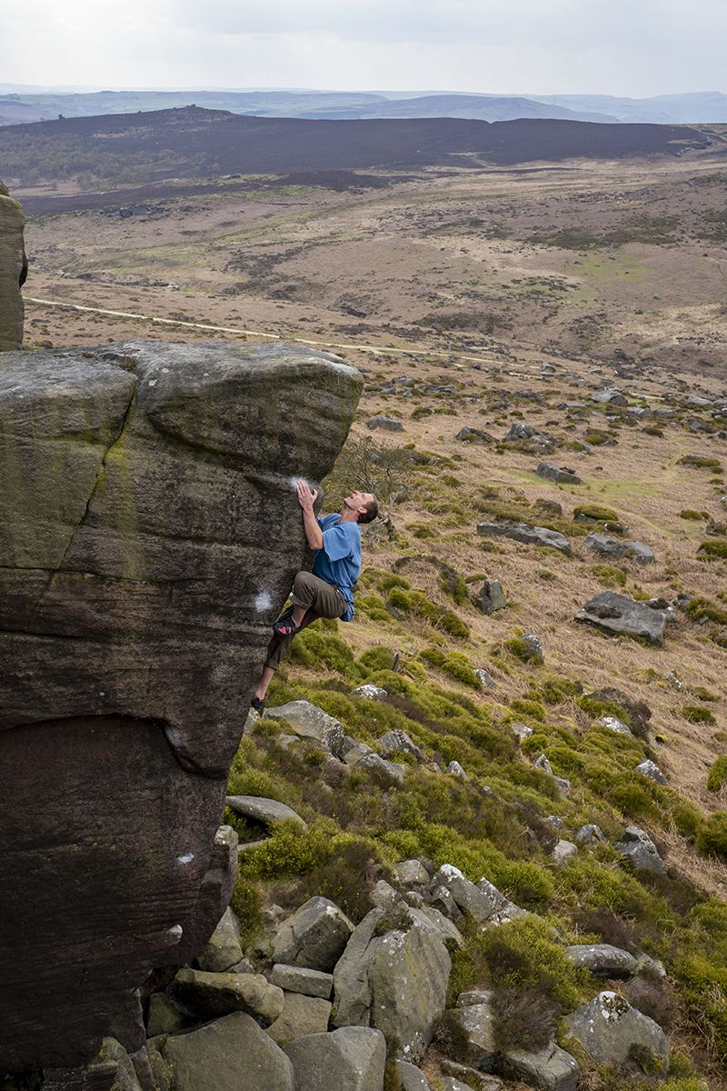 Cliomber on tall boulder