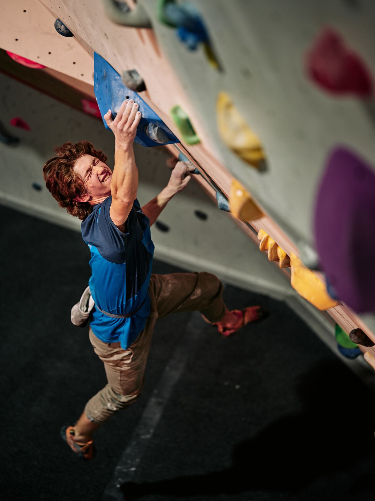 Male competitor on competition boulder problem