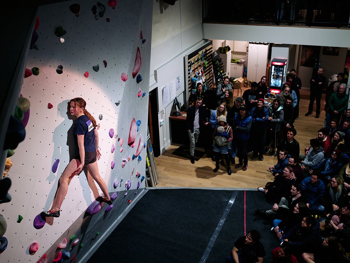 Female competitor on competition boulder problem