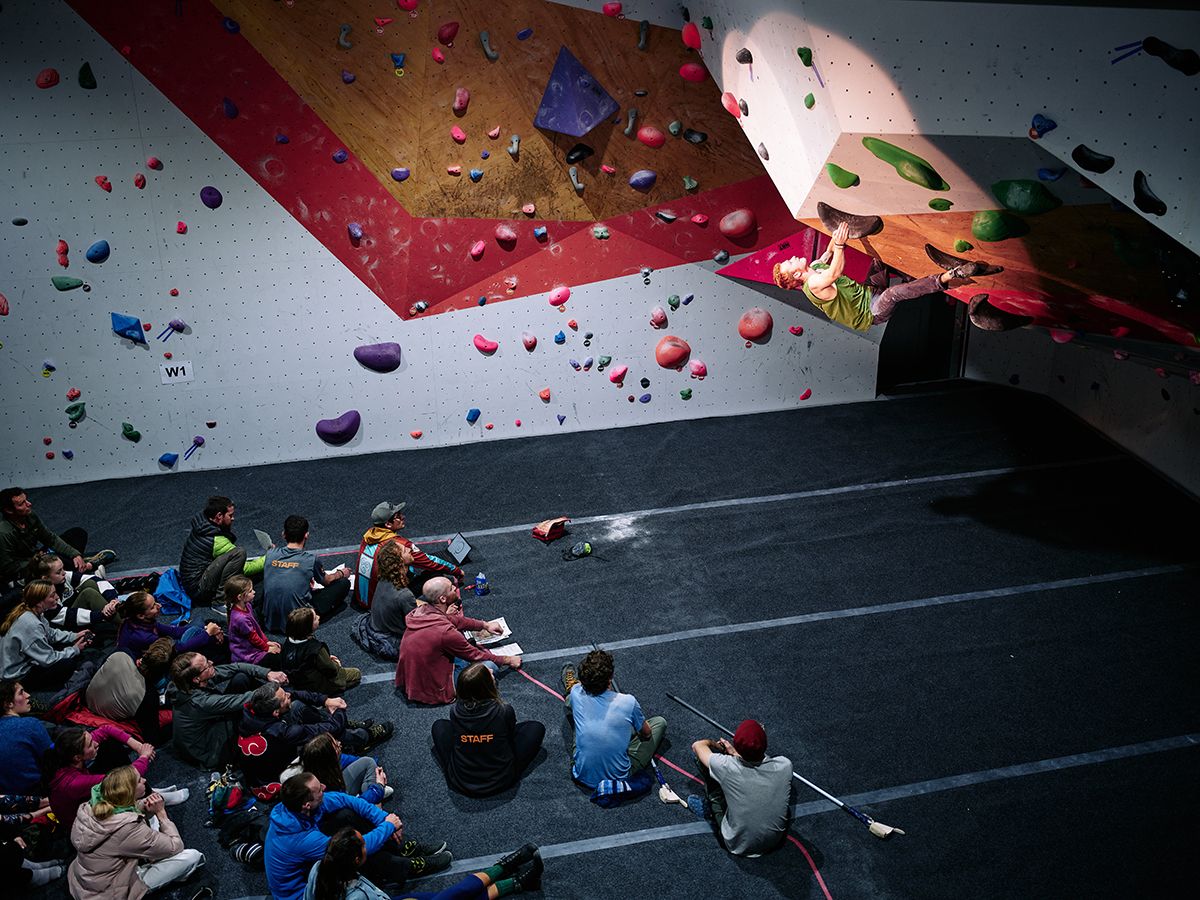 Male competitor on competition boulder problem