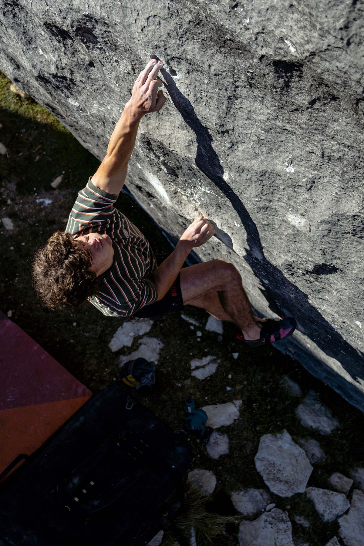 Climber on limestone boulder problem