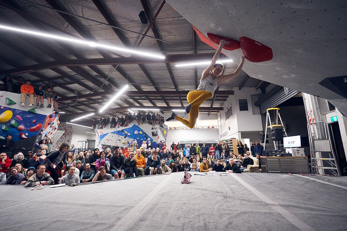 Female bouldering competitor cuts loose