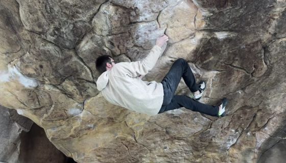 Climber on hard boulder