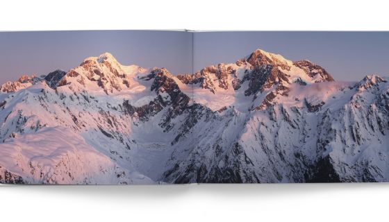Book spread showing mountain photograph