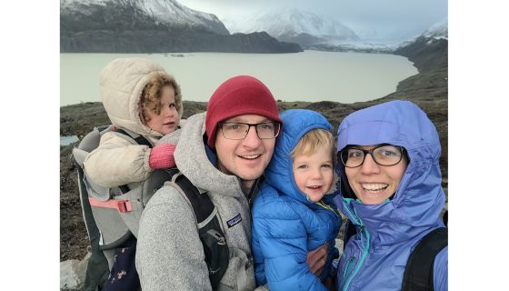 Family portrait in front of glacial lake