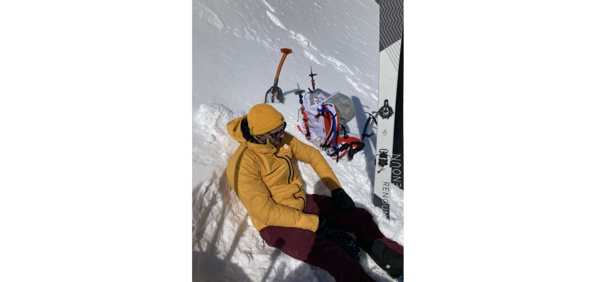 Climber sitting on snowy slope
